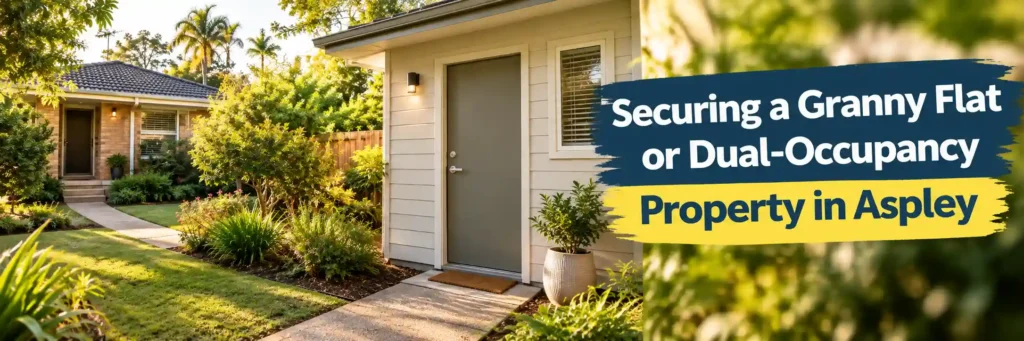 Modern granny flat with separate entry door and pathway beside original 1970s brick main house in Aspley dual-occupancy garden